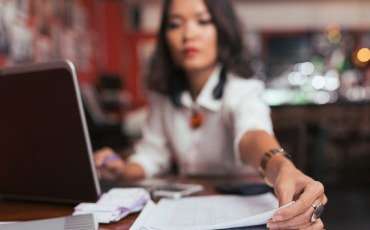 A woman at desk filing papers